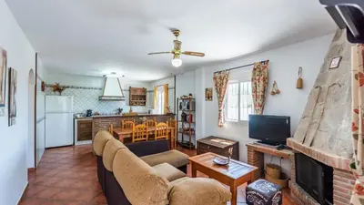 a living room with a couch and a fireplace at Chalet Algar by Ruralidays in Algar