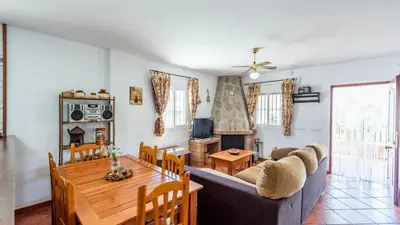 a dining room and living room with a table and a couch at Chalet Algar by Ruralidays in Algar