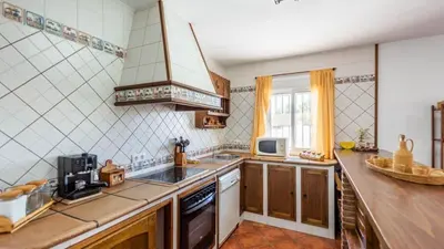 a kitchen with a sink and a stove at Chalet Algar by Ruralidays in Algar