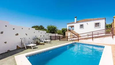 a swimming pool in front of a white house at Chalet Algar by Ruralidays in Algar