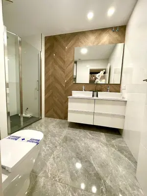 a bathroom with a toilet and a sink and a mirror at Apartamento Cádiz Costa in Cádiz