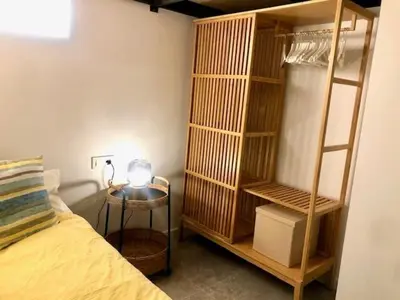 a bedroom with a bed and a table and a book shelf at Apartamento Cádiz Costa in Cádiz