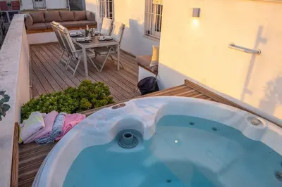 a jacuzzi tub sitting on a patio with a table at Penthouse with Jacuzzi, and garaje Grupo AC Gestion in Cádiz