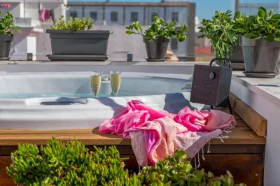 a bath tub with two glasses of champagne at Penthouse with Jacuzzi, and garaje Grupo AC Gestion in Cádiz
