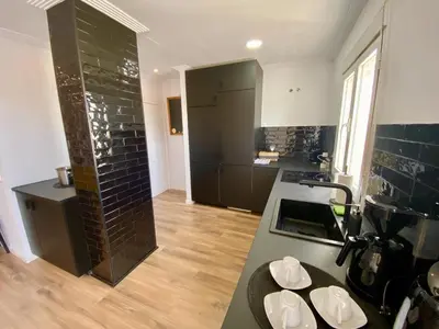 a kitchen with a counter top and a stove top oven at Penthouse with Jacuzzi, and garaje Grupo AC Gestion in Cádiz