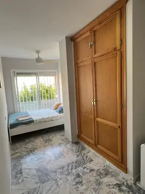 a room with a closet and a bed and a window at Golden Hour Grupo AC Gestión in Rota