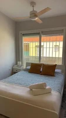 a bedroom with a large bed with a large window at Golden Hour Grupo AC Gestión in Rota