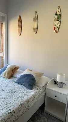 a bedroom with a bed with two pillows and a table at Golden Hour Grupo AC Gestión in Rota
