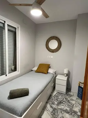 a bedroom with a bed with a mirror and a window at Golden Hour Grupo AC Gestión in Rota