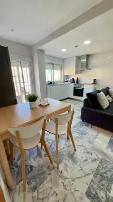 a living room with a table and a couch at Golden Hour Grupo AC Gestión in Rota