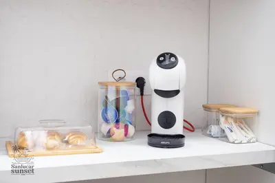 a kitchen counter with a hair dryer on a shelf at Apartamento Sanlúcar Sunset in Sanlúcar de Barrameda