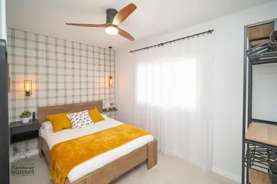 a bedroom with a bed and a ceiling fan at Apartamento Sanlúcar Sunset in Sanlúcar de Barrameda