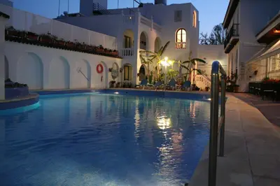 a large swimming pool in front of a building at Brasilia in Chipiona