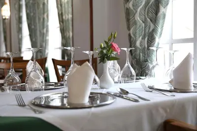 a table with a white table cloth and vases on it at Brasilia in Chipiona