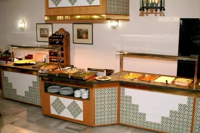 a buffet in a restaurant with a lot of food at Brasilia in Chipiona