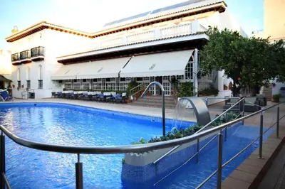 a swimming pool in front of a building at Brasilia in Chipiona