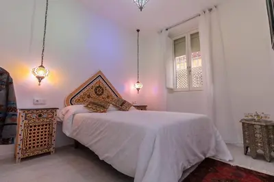 a white bedroom with a bed and a window at SH Rujacor Mare. Apartamento chic en la Viña in Cádiz