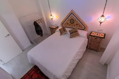 a bedroom with a white bed and two night stands at SH Rujacor Mare. Apartamento chic en la Viña in Cádiz