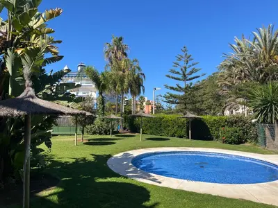 a small swimming pool in a yard with trees at Apartamento en Costa Ballena, Urb. Playa Ballena in Cádiz