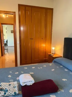 a bedroom with a bed with towels on it at Apartamento en Costa Ballena, Urb. Playa Ballena in Cádiz