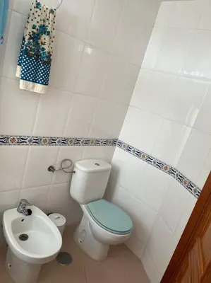 a small bathroom with a toilet and a sink at Apartamento en Costa Ballena, Urb. Playa Ballena in Cádiz