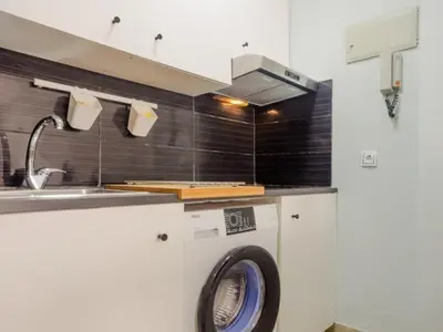a kitchen with a washing machine and a sink at Aparta-club la Barrosa 116 in Chiclana de la Frontera
