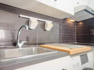 a kitchen with a sink and a faucet at Aparta-club la Barrosa 116 in Chiclana de la Frontera