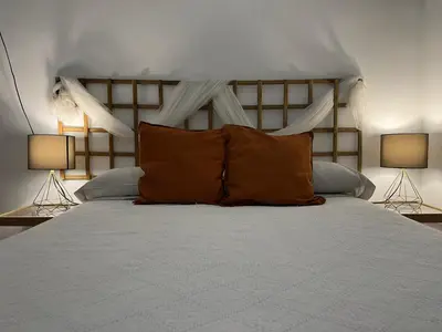 a bedroom with a large bed with two lamps at 50m Playa Caleta y Teatro Falla Grupo AC Gestion in Cádiz