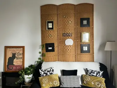 a living room with a couch and a wall with pictures at 50m Playa Caleta y Teatro Falla Grupo AC Gestion in Cádiz