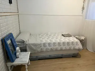 a bedroom with a bed and a table with a mirror at 50m Playa Caleta y Teatro Falla Grupo AC Gestion in Cádiz