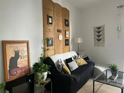 a living room with a black couch in a room at 50m Playa Caleta y Teatro Falla Grupo AC Gestion in Cádiz