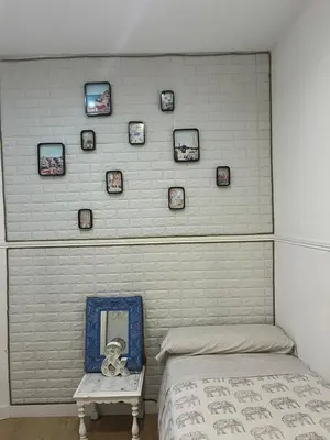 a bedroom with a wall with a mirror and a bed at 50m Playa Caleta y Teatro Falla Grupo AC Gestion in Cádiz