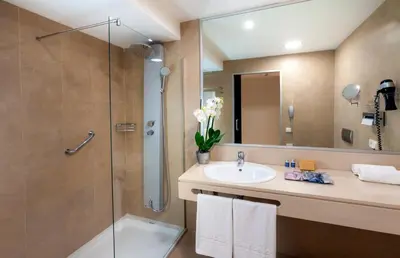 a bathroom with a sink and a shower at Occidental Cádiz in Cádiz