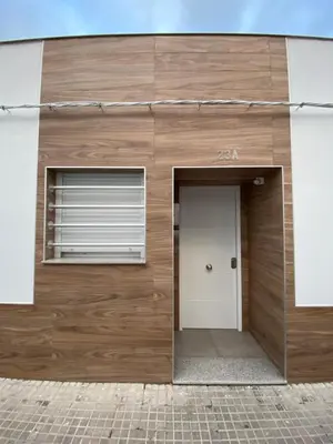 a wooden building with a door and a window at APARTAMENTOS PASCUAL in El Cuervo