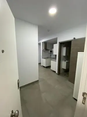 an open door to a room with white walls and tile floors at APARTAMENTOS PASCUAL in El Cuervo