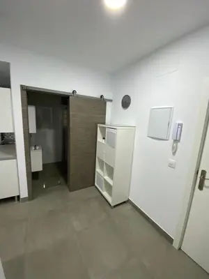an empty room with a refrigerator and a door at APARTAMENTOS PASCUAL in El Cuervo