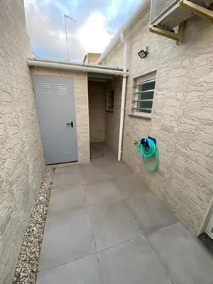 a garage with a door in the side of a building at APARTAMENTOS PASCUAL in El Cuervo