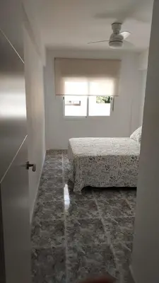 a bedroom with two beds and a window at PISABEL in Sanlúcar de Barrameda