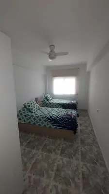 a bedroom with two beds and a window at PISABEL in Sanlúcar de Barrameda