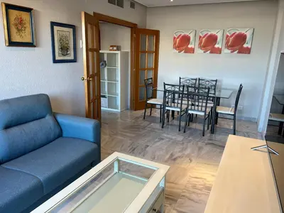 a living room with a couch and a table at Ático primera línea de playa. in Cádiz