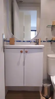 a bathroom with a white sink and a mirror at Sherryflat Trébol - Parking in Jerez de la Frontera