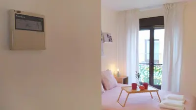 a white room with a bed and a window at Sherryflat Trébol - Parking in Jerez de la Frontera