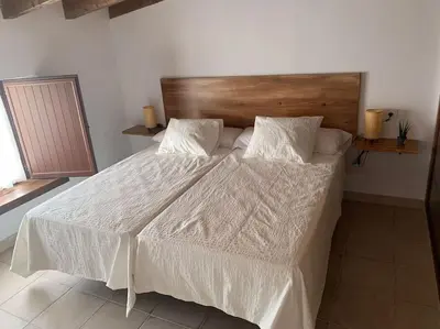 a bedroom with a large bed with a wooden headboard at Santa Lucía in Jerez de la Frontera