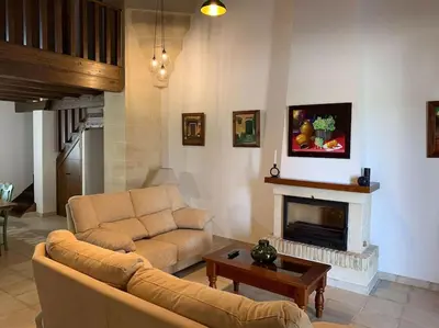 a living room with a couch and a fireplace at Santa Lucía in Jerez de la Frontera