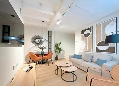 a living room with a couch and a table at Apartamentos Soho Boutique Palillero in Cádiz
