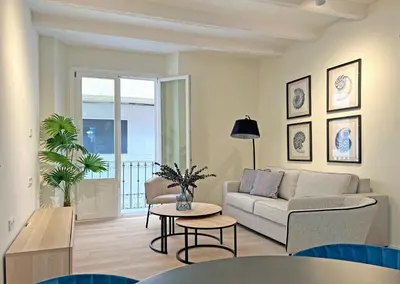 a living room with a couch and a table at Apartamentos Soho Boutique Palillero in Cádiz