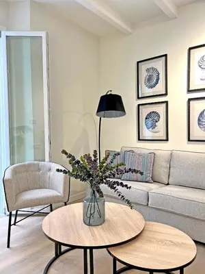 a living room with a couch and a table at Apartamentos Soho Boutique Palillero in Cádiz