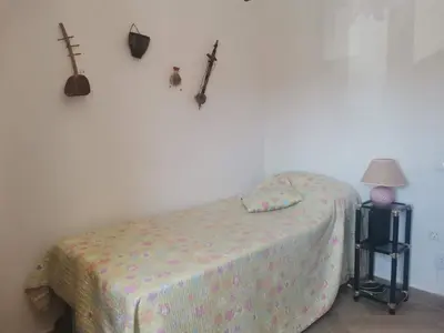 a bedroom with a bed and a guitar on the wall at Estadio 3 in Cádiz