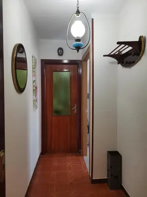 a hallway with a wooden door and a light at Estadio 3 in Cádiz