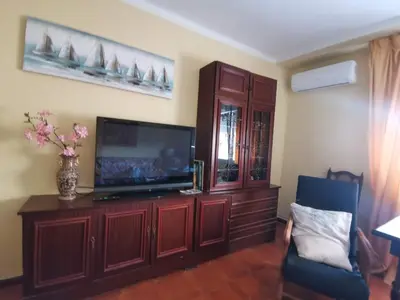 a living room with a tv and a entertainment center at Estadio 3 in Cádiz